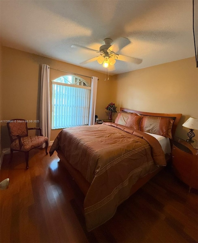 bedroom with ceiling fan and hardwood / wood-style floors