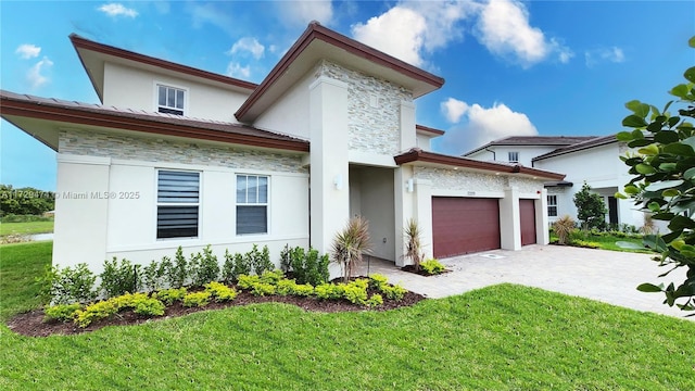 view of front of home with a front lawn and a garage