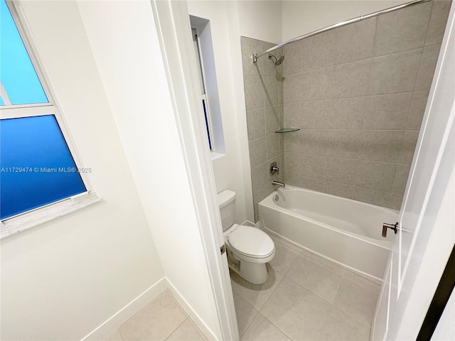 bathroom featuring toilet, tiled shower / bath combo, and tile patterned floors