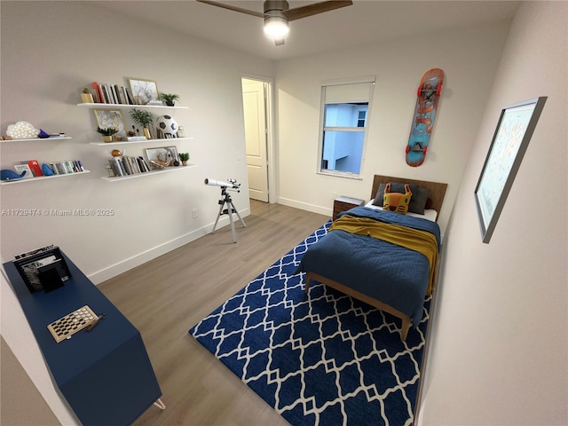 bedroom with ceiling fan and hardwood / wood-style flooring