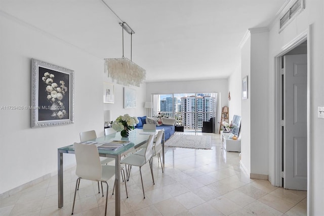 300 Bayview Dr Unit 1503, Sunny Isles Beach, FL 33160 - dining area featuring light tile patterned flooring and crown molding