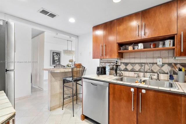 300 Bayview Dr Unit 1503, Sunny Isles Beach, FL 33160 - kitchen featuring stainless steel appliances, open shelves, tile countertops, decorative backsplash, and recessed lighting