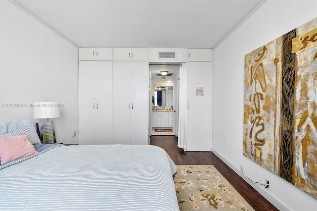 300 Bayview Dr Unit 1503, Sunny Isles Beach, FL 33160 - bedroom featuring dark wood-type flooring, ornamental molding, and a closet