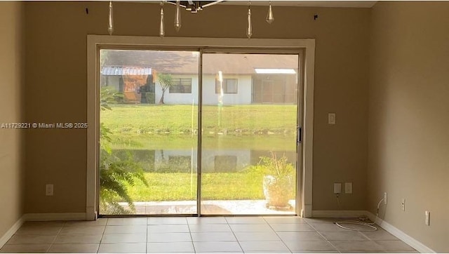 entryway featuring light tile patterned flooring and a water view