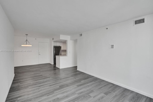 unfurnished living room with wood-type flooring