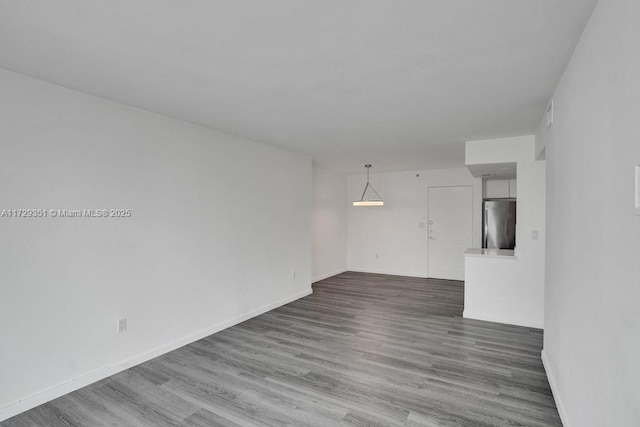 spare room featuring wood-type flooring