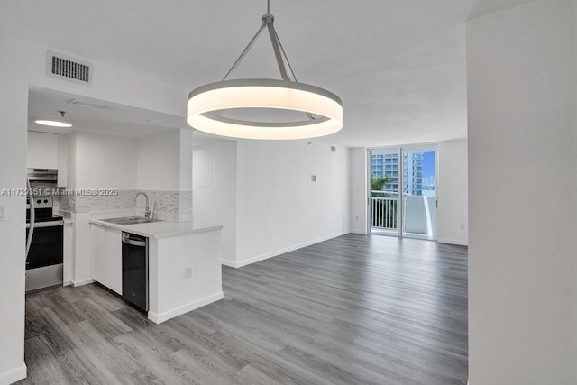 kitchen with pendant lighting, sink, stainless steel electric range oven, white cabinetry, and black dishwasher