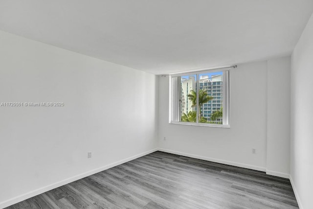 empty room with dark hardwood / wood-style floors