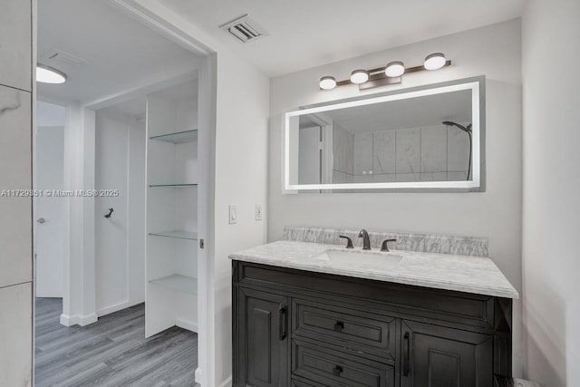 bathroom with hardwood / wood-style floors and vanity