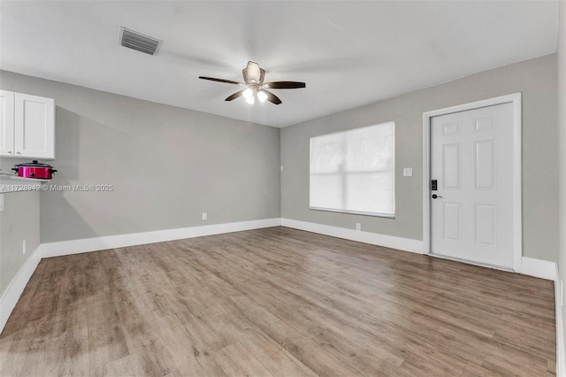 spare room featuring ceiling fan and light wood-type flooring