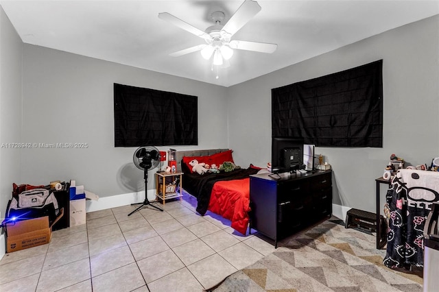 bedroom with ceiling fan and light tile patterned flooring