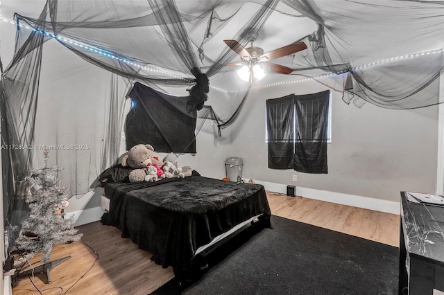 bedroom with ceiling fan and hardwood / wood-style flooring