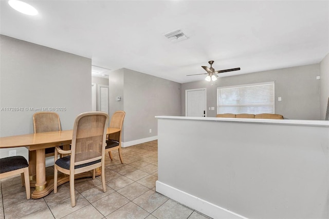 tiled dining space featuring ceiling fan