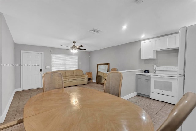 tiled dining space featuring ceiling fan