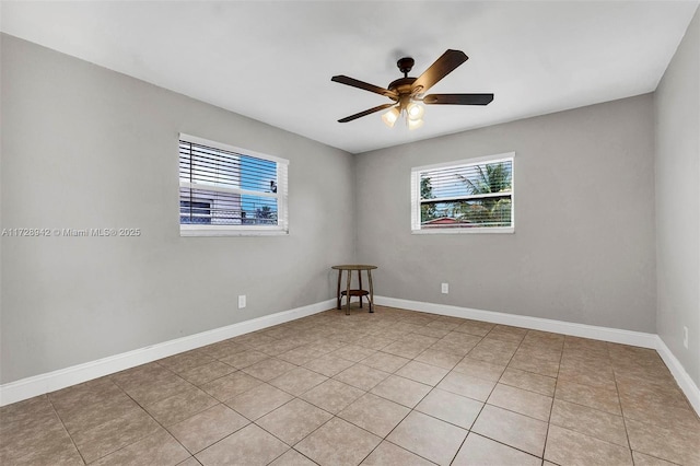 empty room featuring ceiling fan and light tile patterned flooring