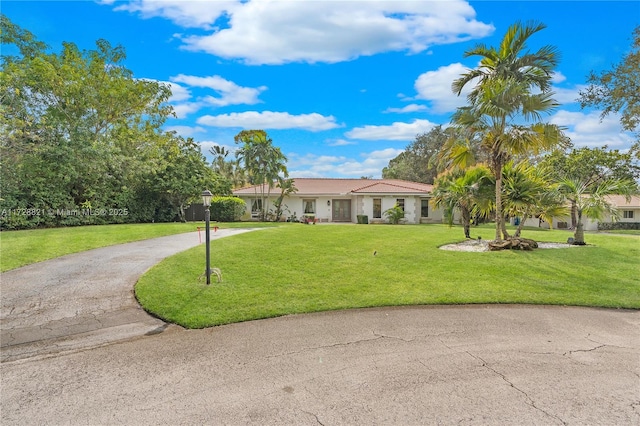 ranch-style home featuring a front yard