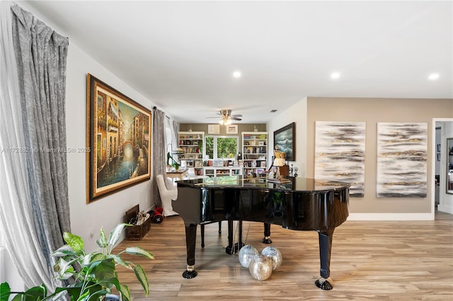 miscellaneous room with ceiling fan and light hardwood / wood-style floors