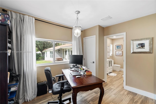 office area with light hardwood / wood-style floors