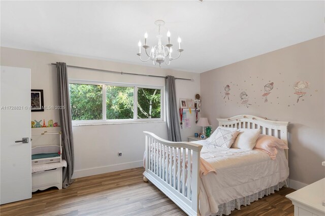 bedroom featuring a notable chandelier and light wood-type flooring