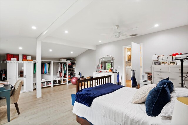 bedroom with washer / clothes dryer, beam ceiling, light hardwood / wood-style floors, and ceiling fan