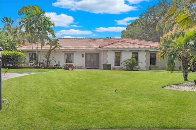 view of front facade with french doors and a front lawn