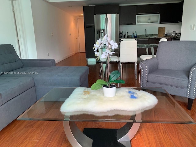 living room featuring sink and light hardwood / wood-style floors