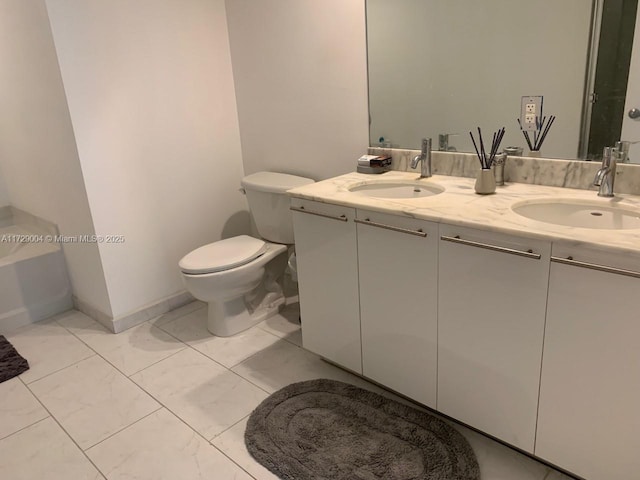 bathroom with toilet and vanity