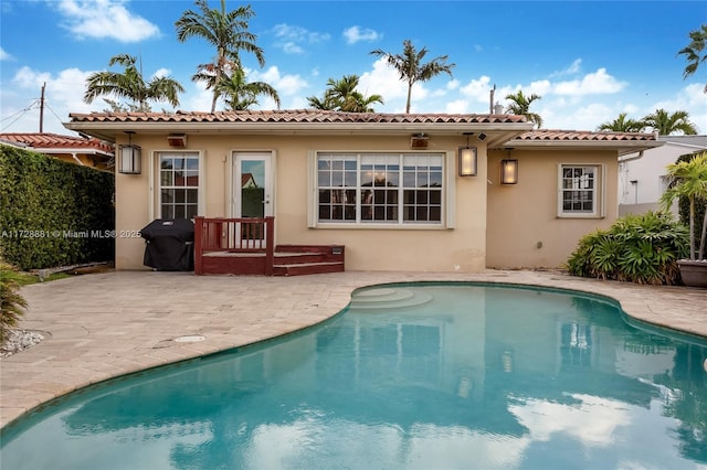 rear view of property featuring a patio area