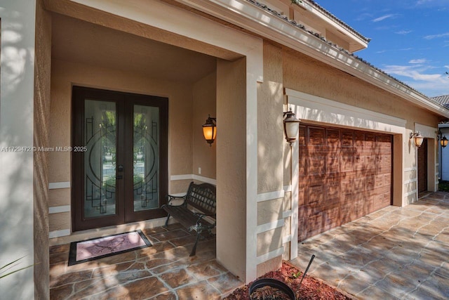 doorway to property featuring french doors and a garage