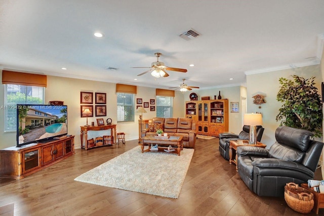 living room featuring ornamental molding and light wood-type flooring