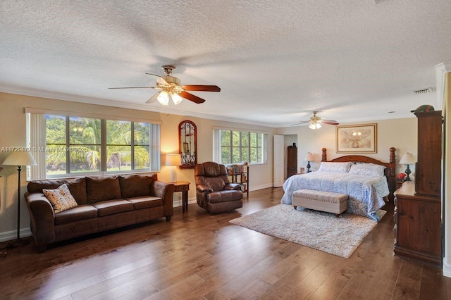 bedroom featuring ceiling fan, dark wood-type flooring, crown molding, and a textured ceiling