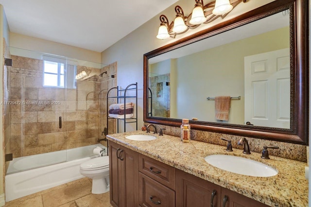 full bathroom with bath / shower combo with glass door, toilet, and vanity