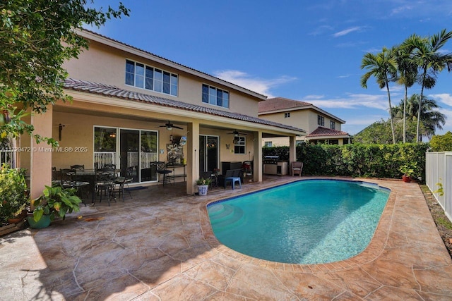 view of pool with ceiling fan and a patio area