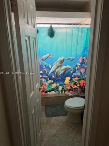 bathroom featuring toilet and tile patterned floors