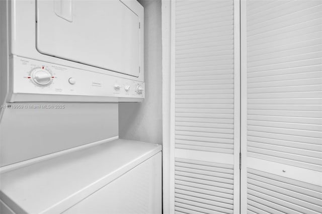 clothes washing area featuring stacked washer / drying machine