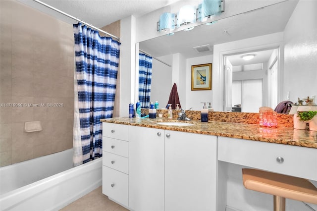 bathroom with a textured ceiling, shower / tub combo, tile patterned floors, and vanity