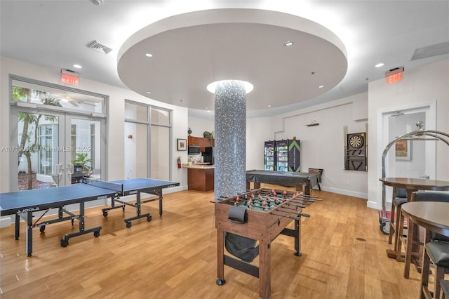 recreation room with light hardwood / wood-style floors and french doors