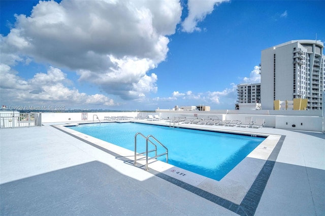 view of swimming pool featuring a patio area