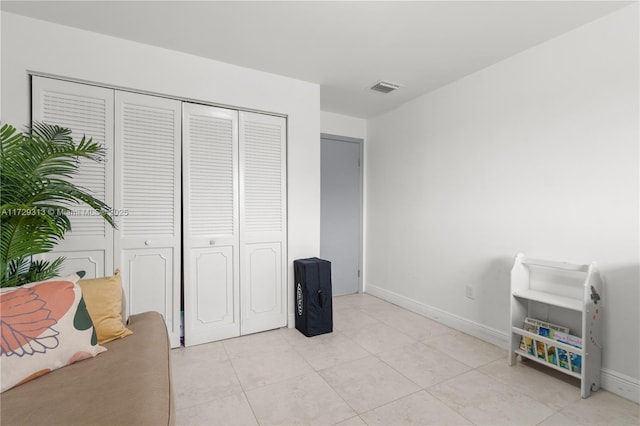 interior space with a closet and light tile patterned floors