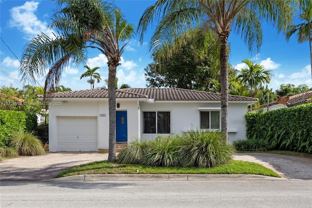 mediterranean / spanish-style house with a garage