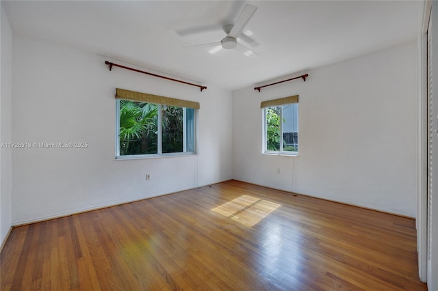 spare room featuring hardwood / wood-style floors and ceiling fan