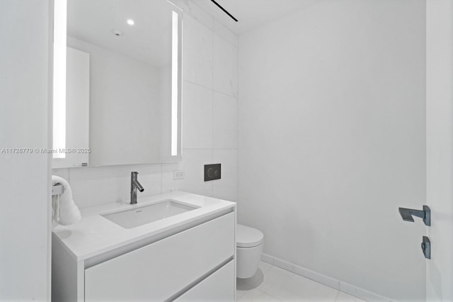 bathroom featuring toilet, tile patterned flooring, and vanity