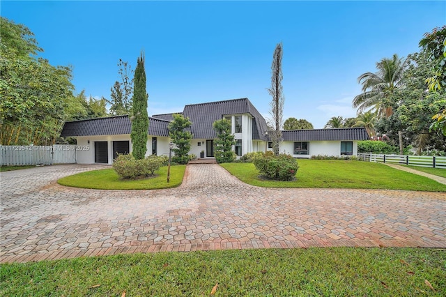 view of front facade with a garage and a front lawn