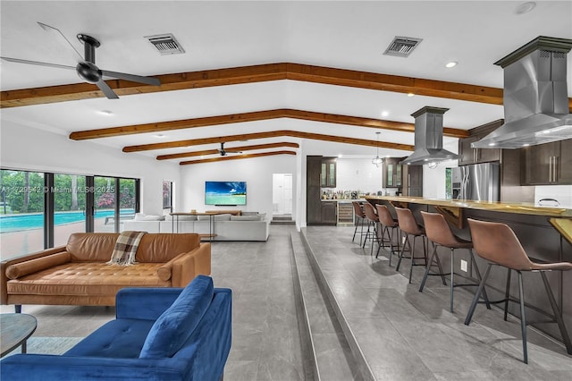 living room featuring ceiling fan and lofted ceiling with beams