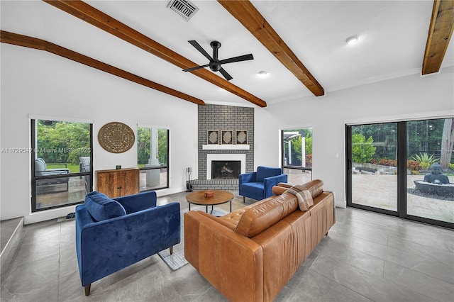 living room with ceiling fan, beamed ceiling, and a fireplace