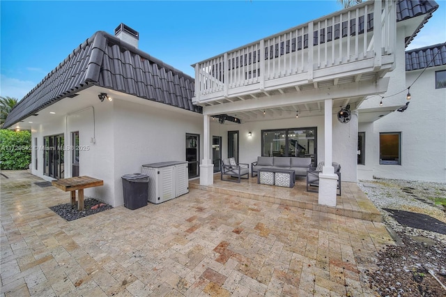 view of patio with french doors, a balcony, and an outdoor hangout area