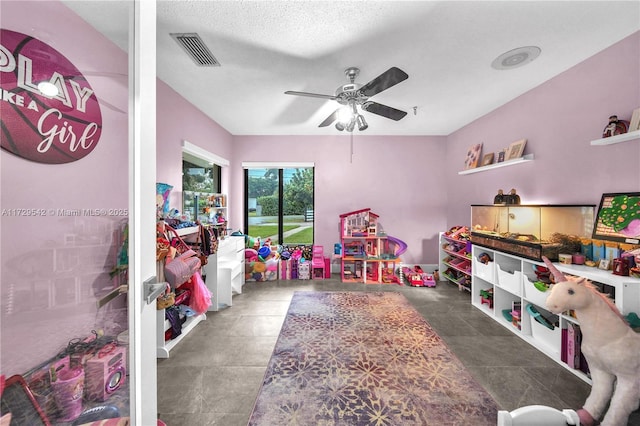 rec room featuring a textured ceiling and ceiling fan