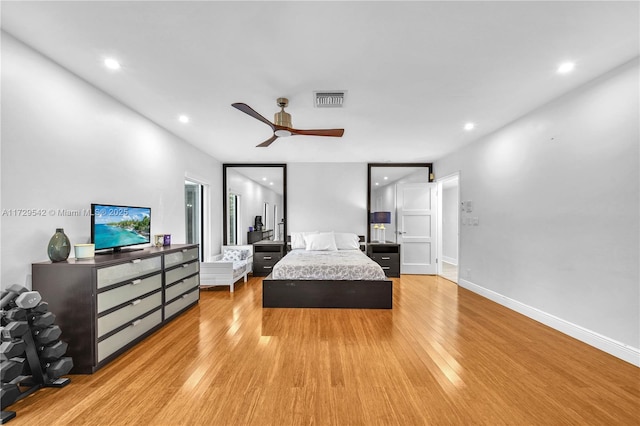 bedroom with light hardwood / wood-style floors and ceiling fan