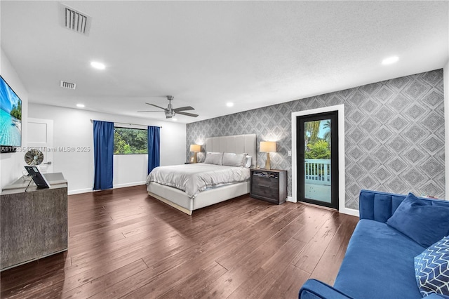 bedroom featuring ceiling fan, access to exterior, and dark wood-type flooring