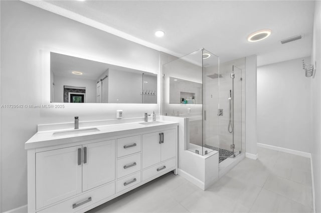 bathroom featuring vanity, walk in shower, and tile patterned flooring